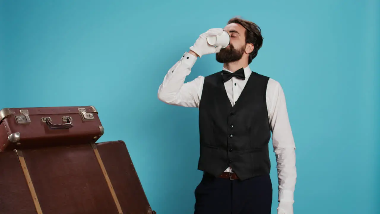 Hotel porter enjoying coffee cup