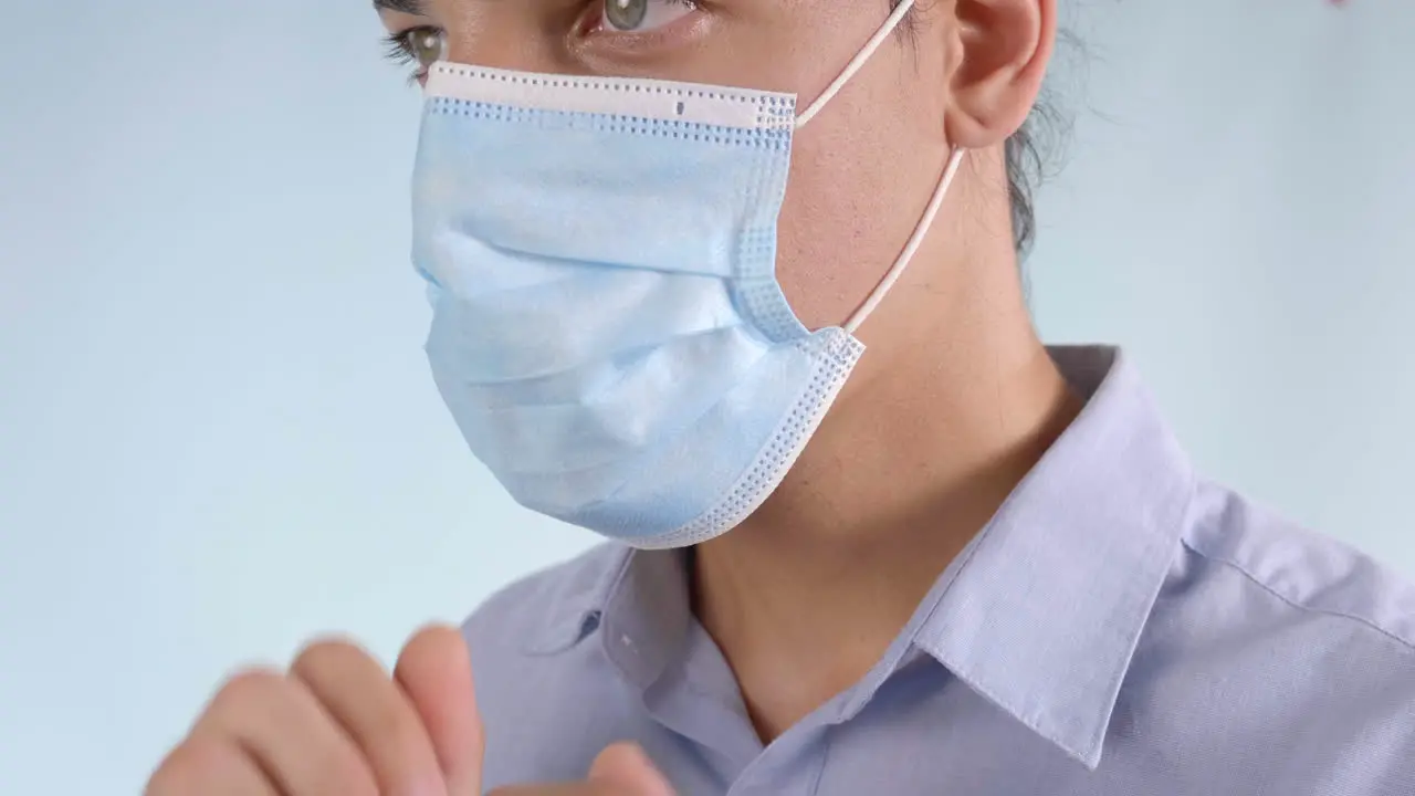 Extreme Closeup of Man Putting on Disposable Face Mask