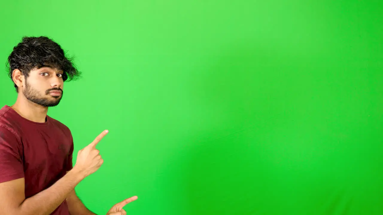 Indian guy point out with green background indian guy standing on green screen chroma key