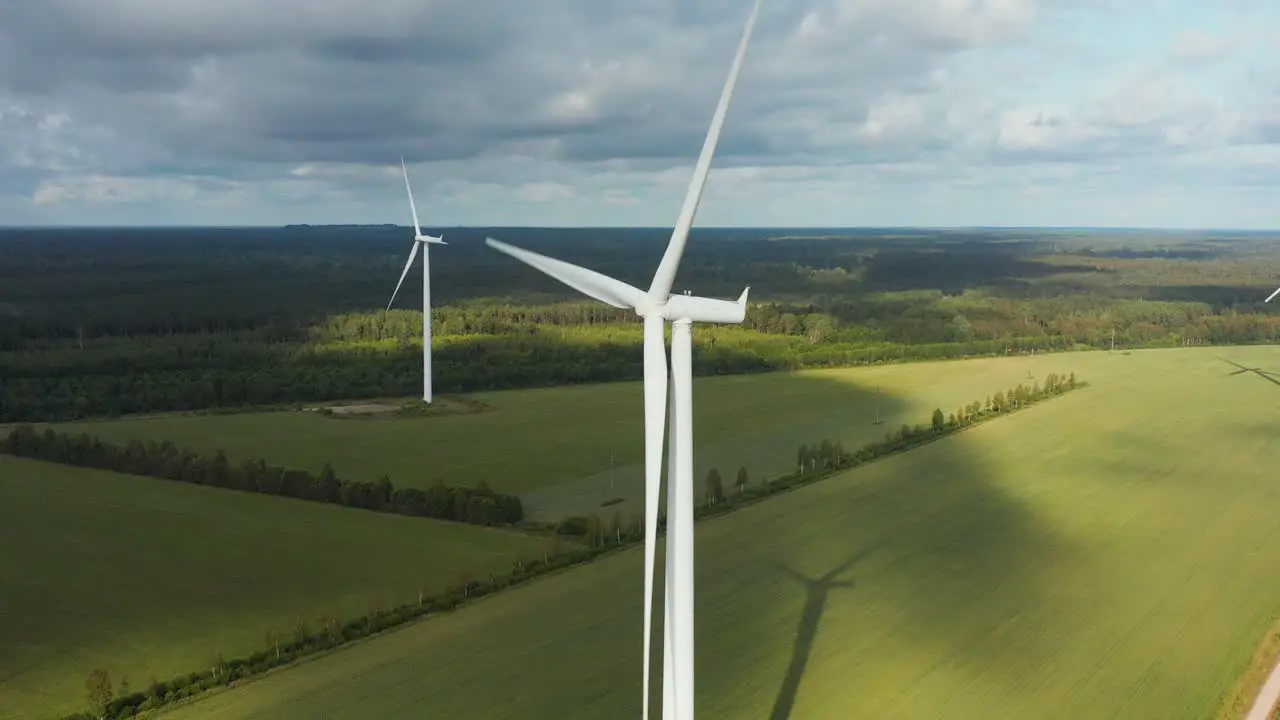 Aerial view of a rotating wind turbine energy generation park