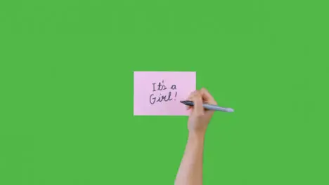 Woman Writing Its A Girl on Paper with Green Screen