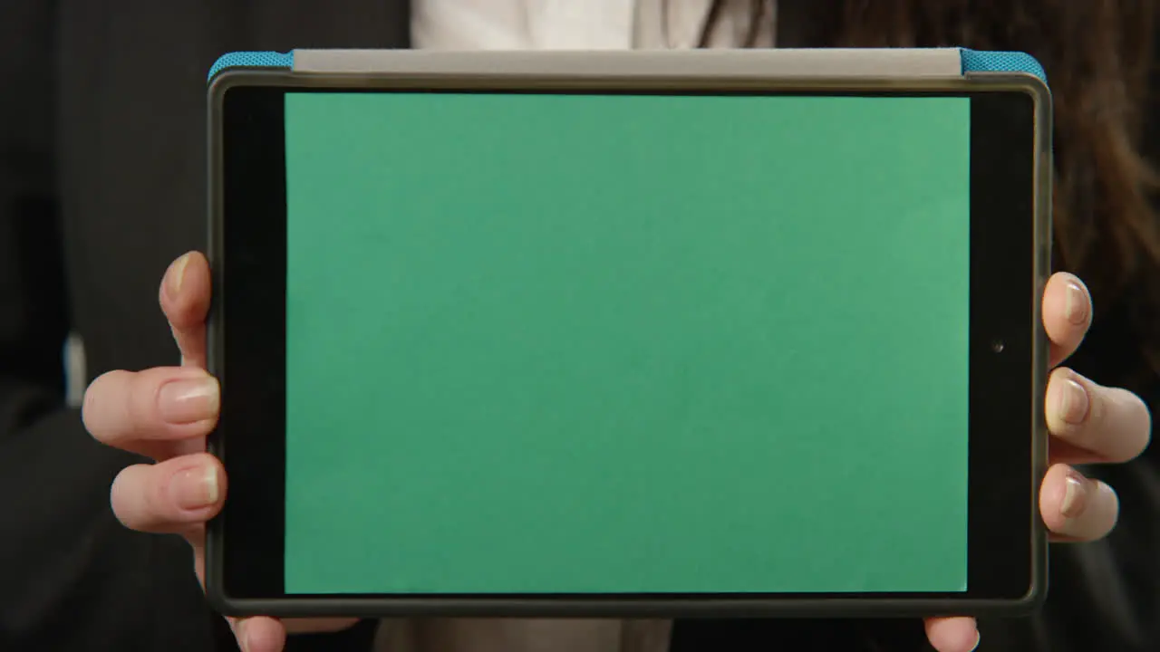 Woman Holding Tablet with Green Screen At Camera