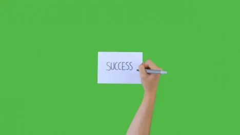 Woman Writing Success on Paper with Green Screen