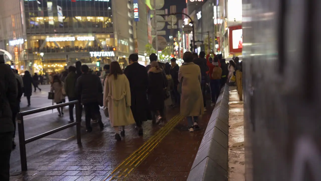 Pedestrians in Shibuya walking to cross the Shibuya Scramble