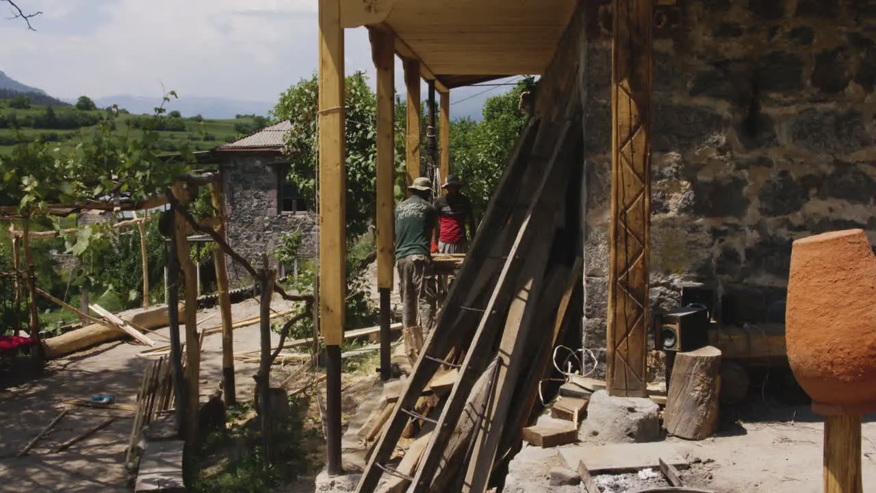 Two Carpenters Working on Traditional Georgian House Chobareti Georgia Pan