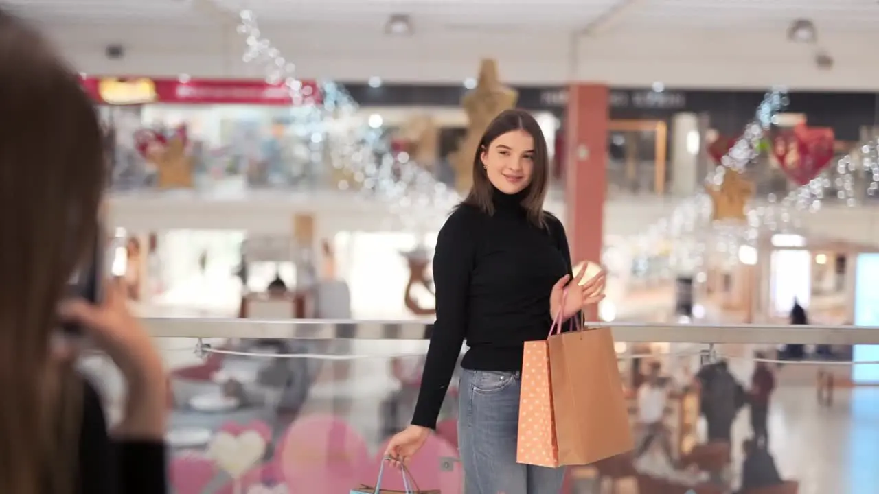 young girl is photographed with packages after shopping