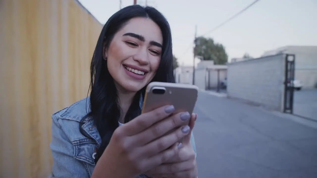 Smiling young girl checking her phone