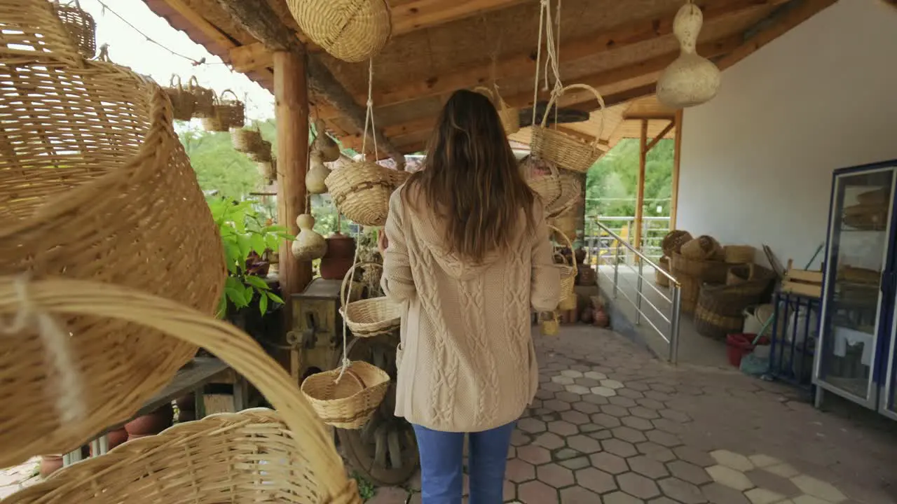 Woman buying wicker basket in a household goods store