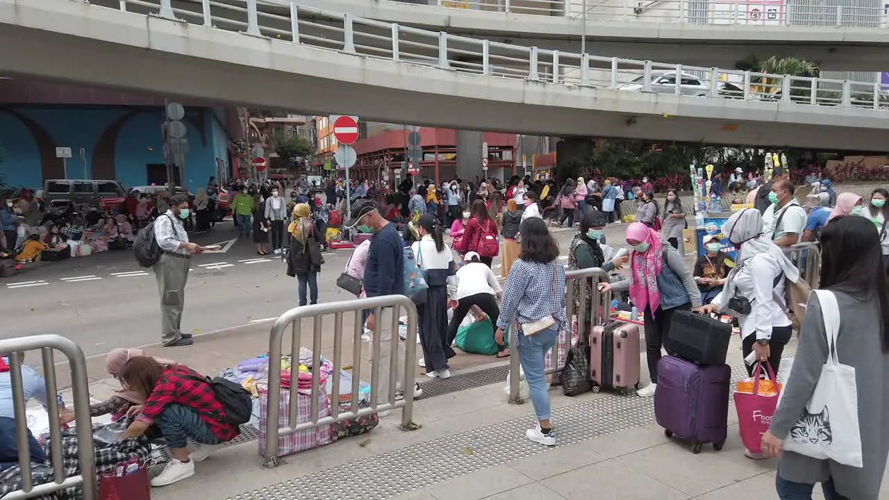 CoronaVirus Pandemic Sunday gathering of local Women wearing protective face masks in downtown Hong Kong with traffic passing by