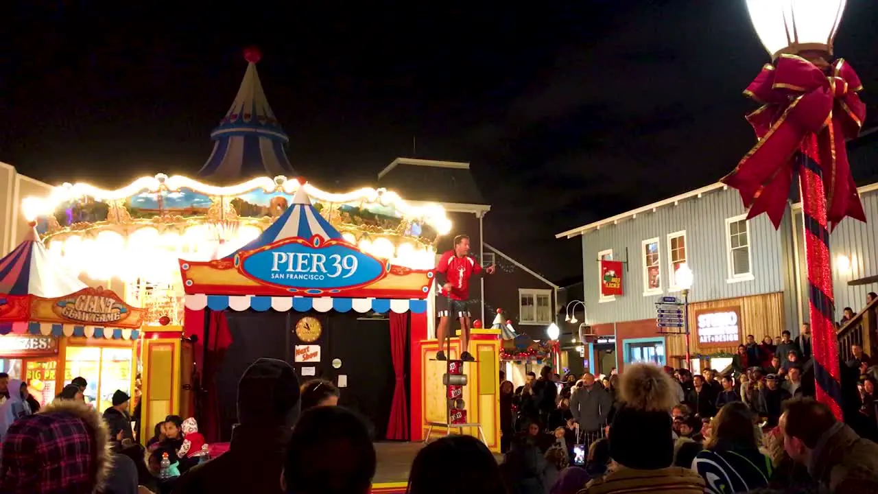 Street performer balancing on multiple aluminium-metal container-tin at Pier 39 in San francisco during the time of New year eve