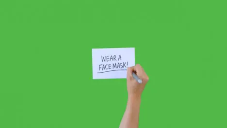 Woman Writing Wear a Facemask on Paper with Green Screen