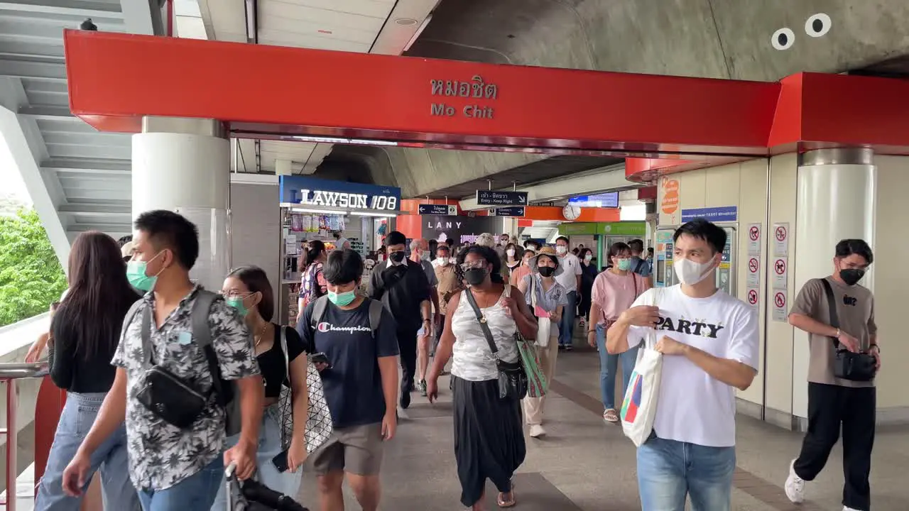 Crowd of people exiting Mo Chit BTS Skytrain station in Bangkok