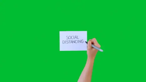 Woman Writing Social Distancing on Paper with Green Screen