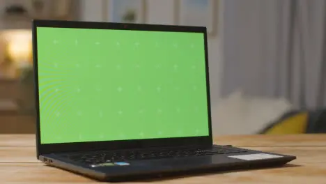 Green Screen Laptop On Table At Home