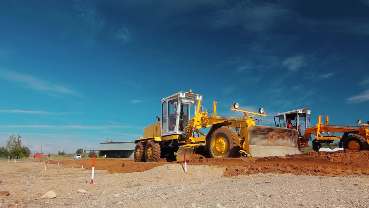 Grader leveling ground on construction site before kick off building project