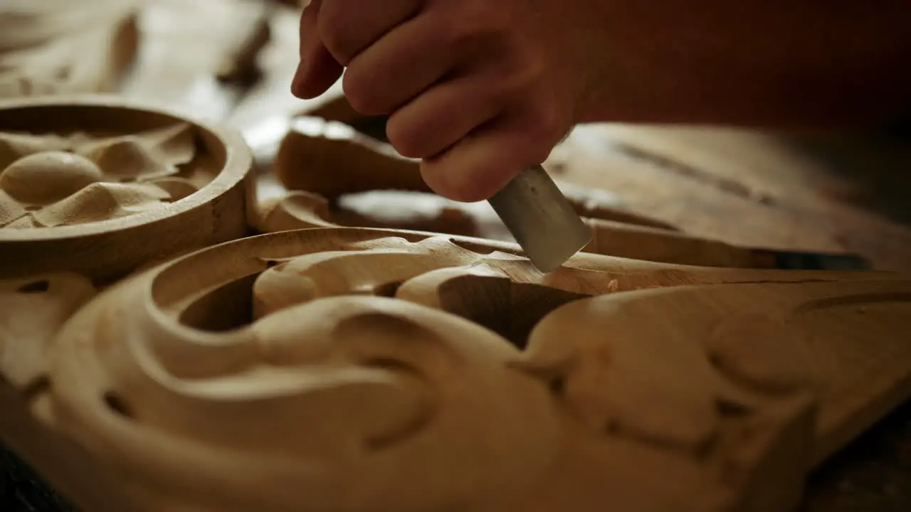 Woodmaker using tools indoors Unknown man carving wood in carpentry workshop