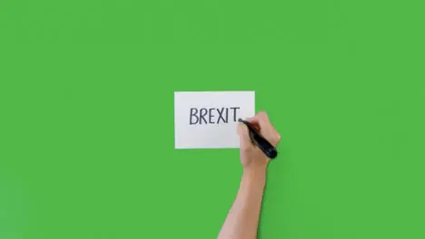 Woman Writing Brexit on Paper with Green Screen