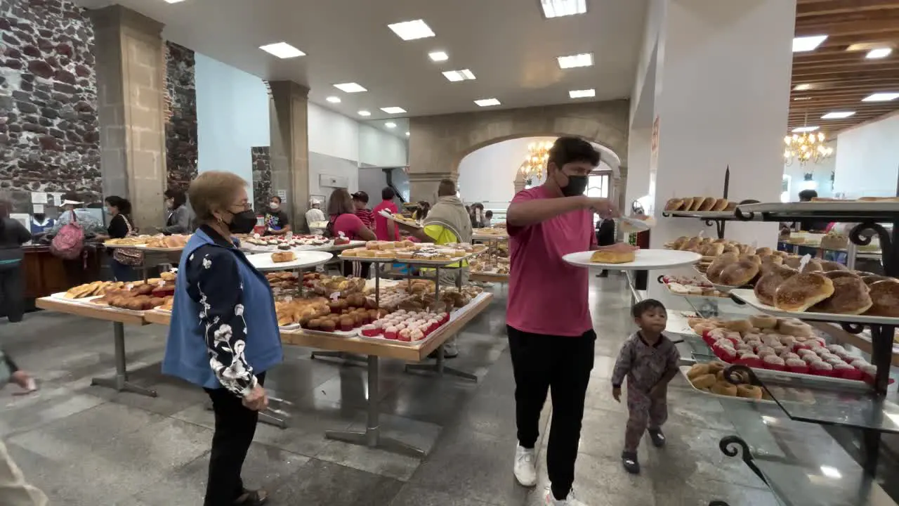 shot of people buying bread in a bakery in the center of mexico city