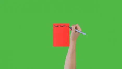 Woman Writing Dear Santa on Paper with Green Screen