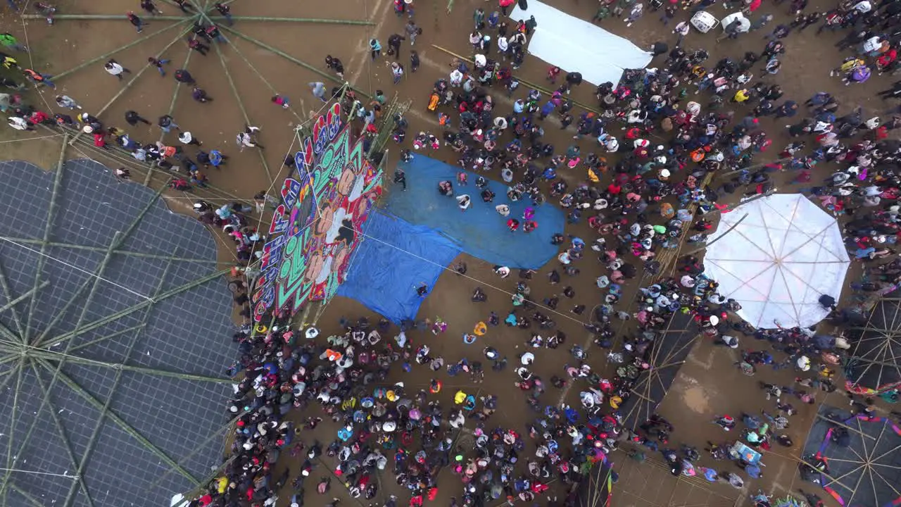 Big colourful kite with lot of people around at Sumpango Guatemala aerial