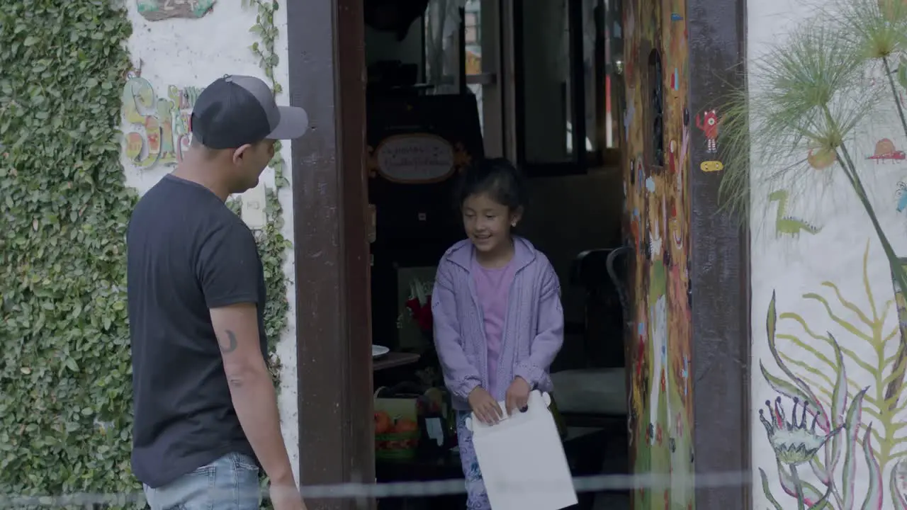 Static shot of a young man collecting two boxes of a grandmother and a young girl