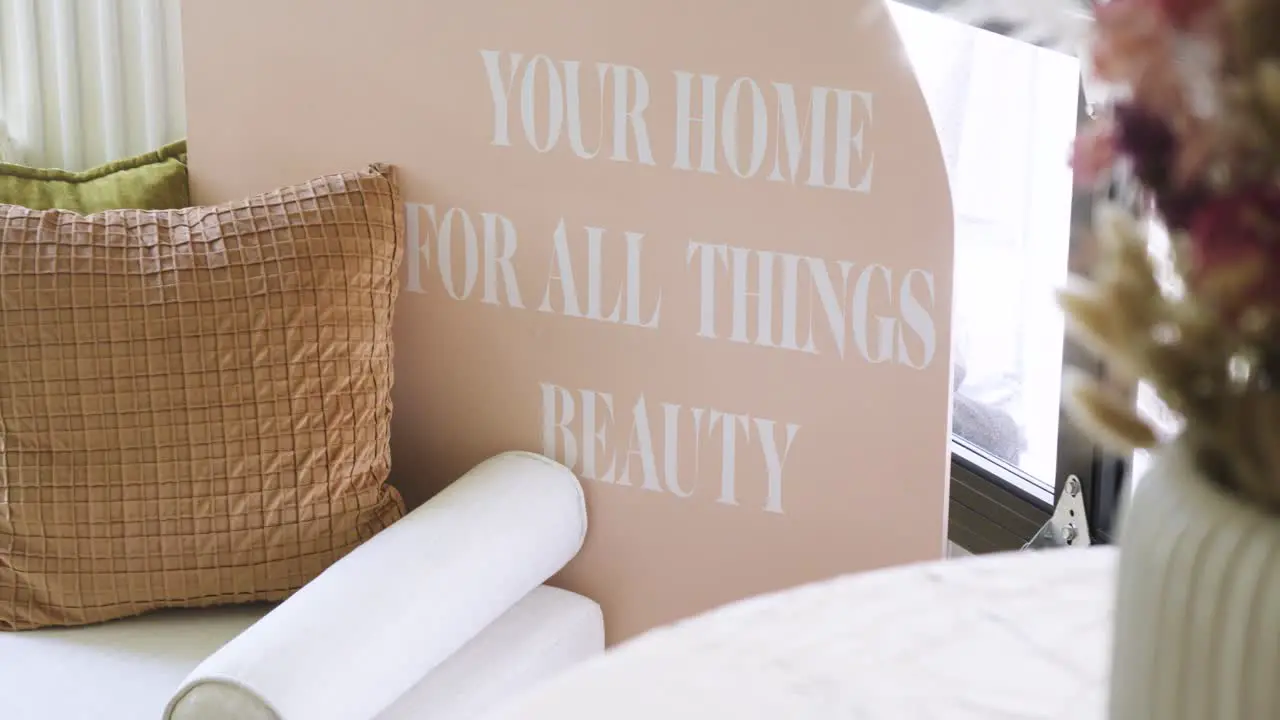 Slow revealing shot of a beauty sign with floral decorations in a waiting room