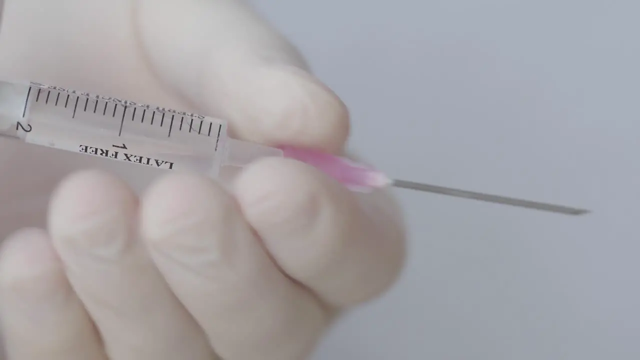 Hand With Glove Remove Needle From Syringe Close Up Shot