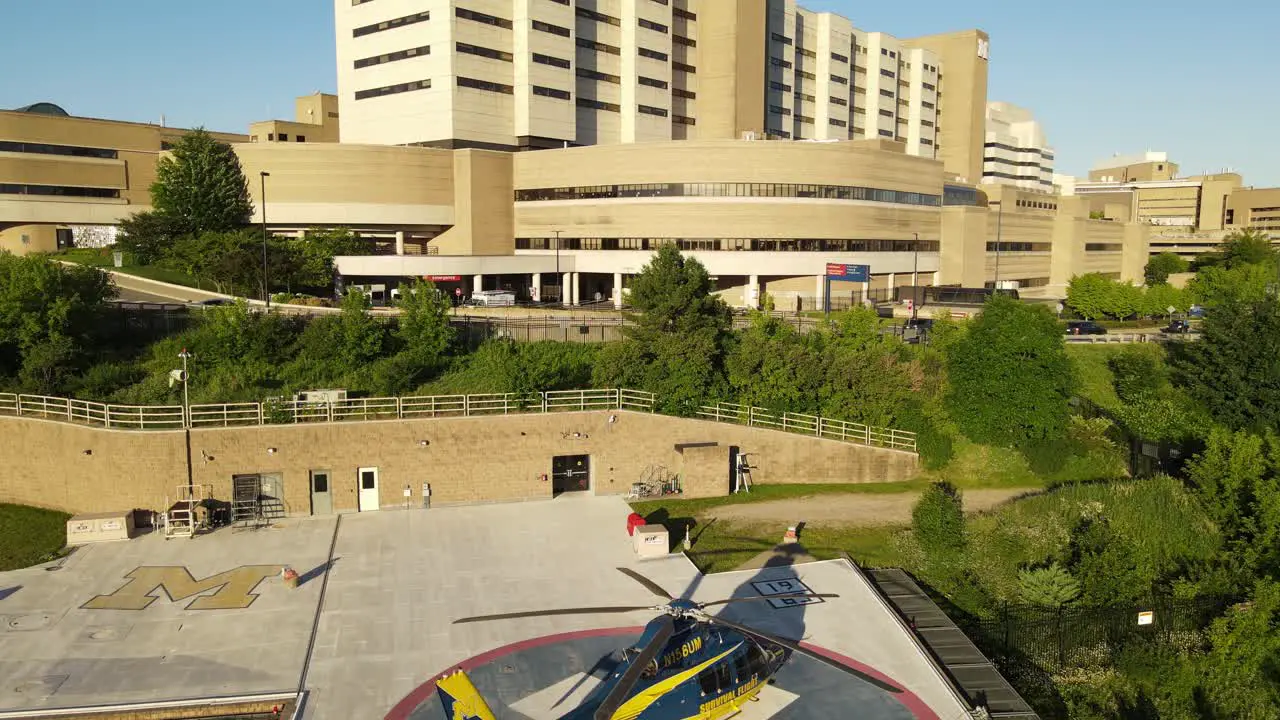 Modern helicopter near University of Michigan Hospital aerial ascend view