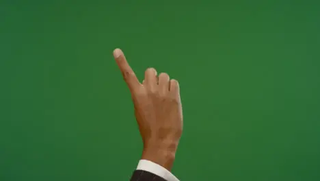 Male finger making swiping gestures on green screen