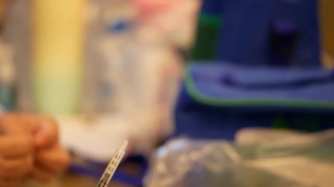 Close Up Footage of Registered Nurse Pulling Covid-19 Vaccine Booster Out By Using Syringe