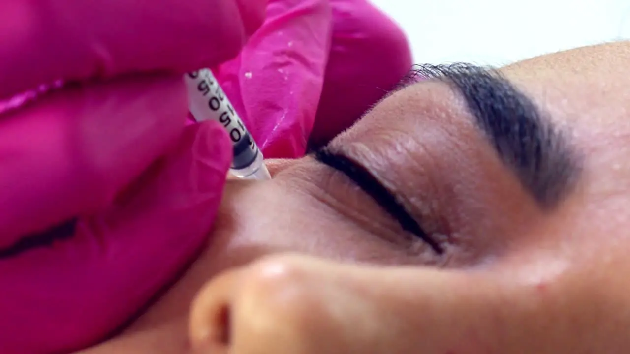 Hispanic female getting Botox injections close up