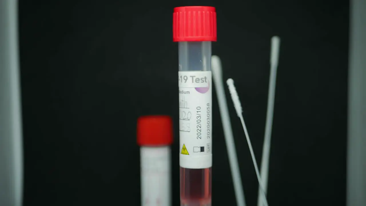 Nasopharyngeal Swab For Coronavirus In Dublin Ireland Test Tube With COVID-19 Test Sample Spinning With A 6-inch Cotton Swabs In The Background