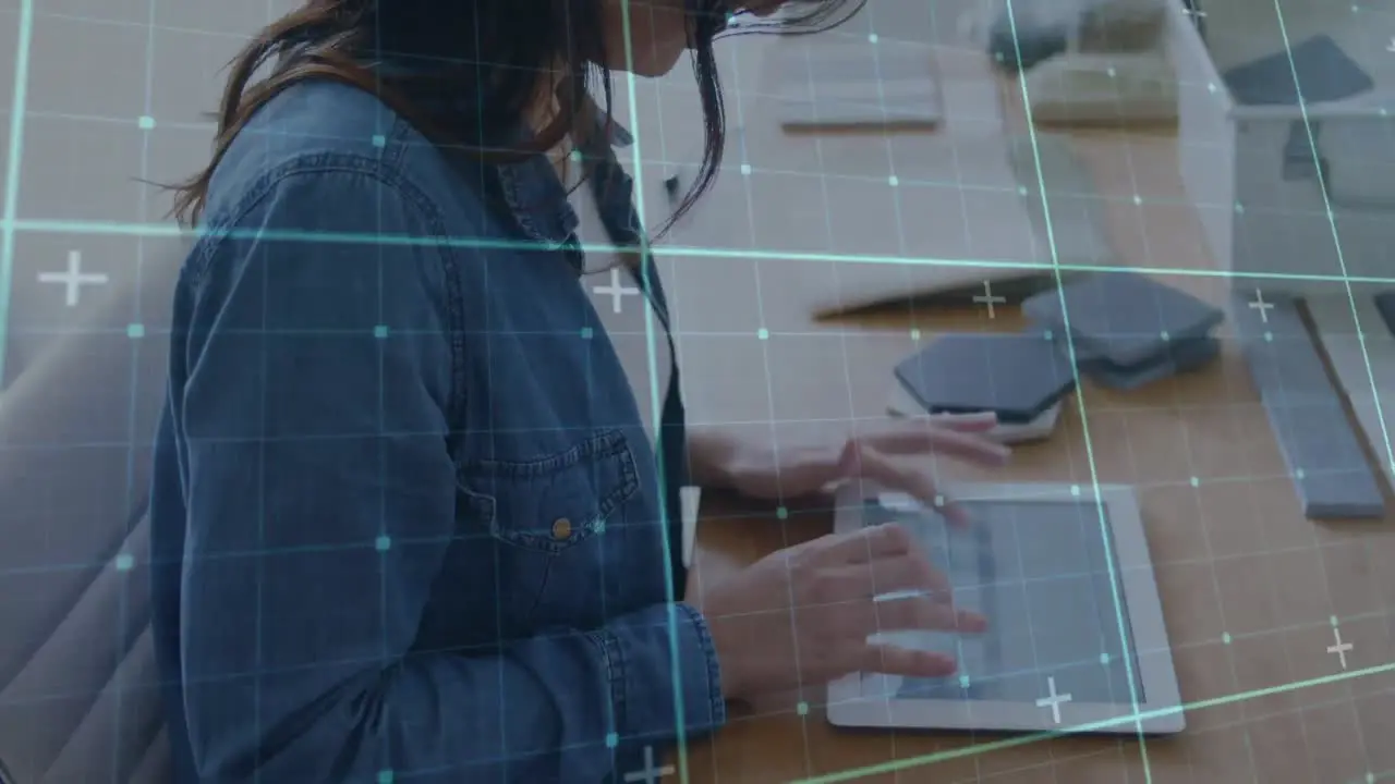 Animation of data processing on digital screen over caucasian woman using tablet in office