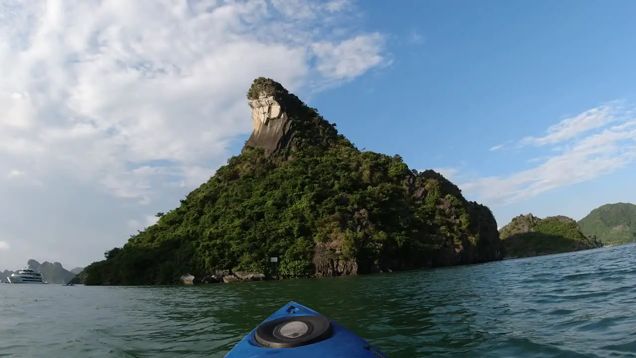 Kayaking to a limestone island in Halong Bay Vietnam