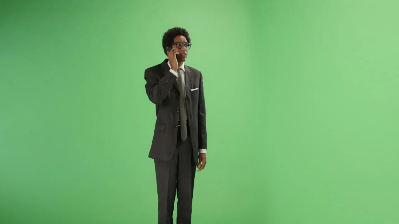 Businessman talking on phone with green screen