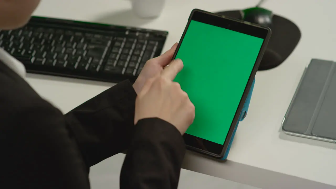 CU Woman making swiping gestures on tablet with green screen