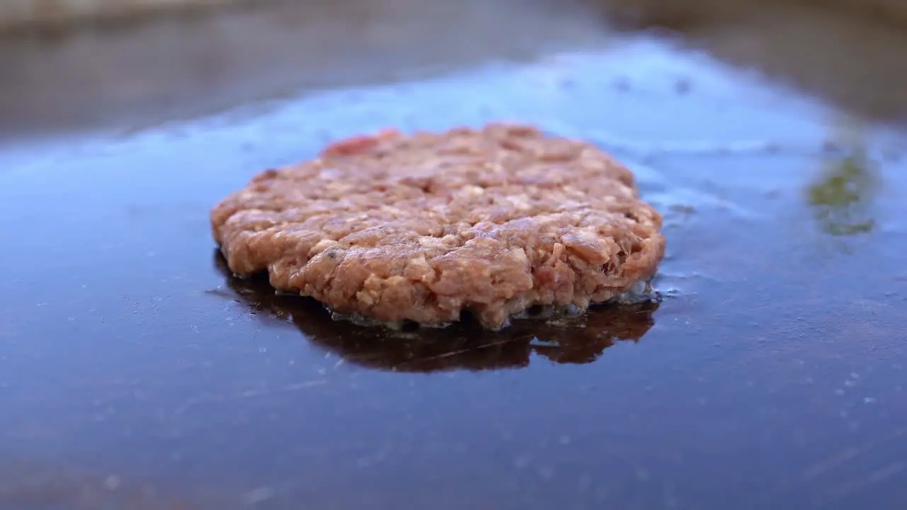 Beef burger is cooking on the grill