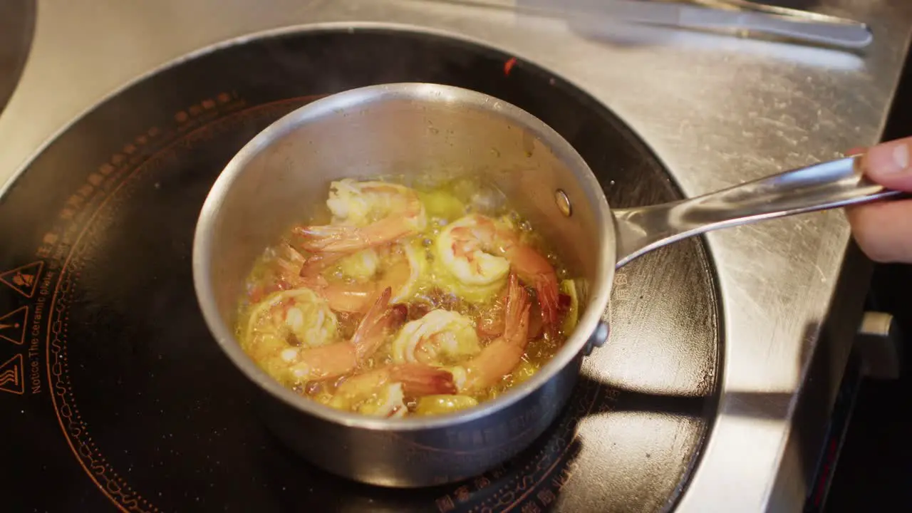 Chef preparing Mediterranean shrimp seafood soup in a pot professional kitchen restaurant footage