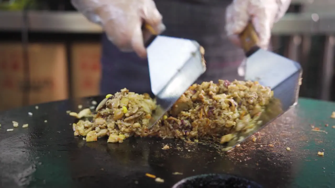 Cooking Fried Rice With Mushroom On Hot Griddle Using Spatula In Kitchen