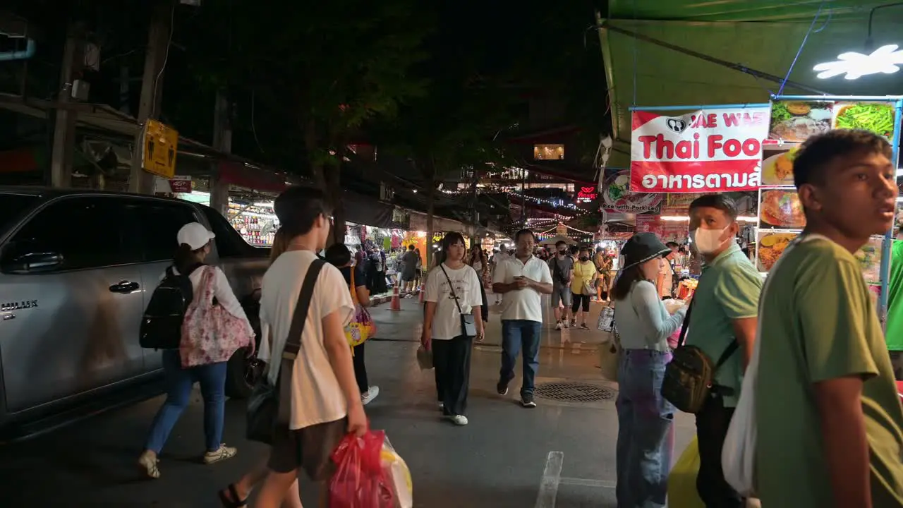 Chatuchak Weekend Night Market filled with local and foreign tourists who are looking for food being sold by hawkers in Chatuchak Bangkok Thailand