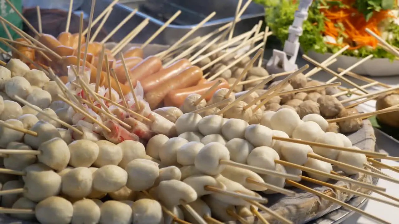 Close-up Footage of Many Kinds of Steamed Skewers Displaying At Street Food Market