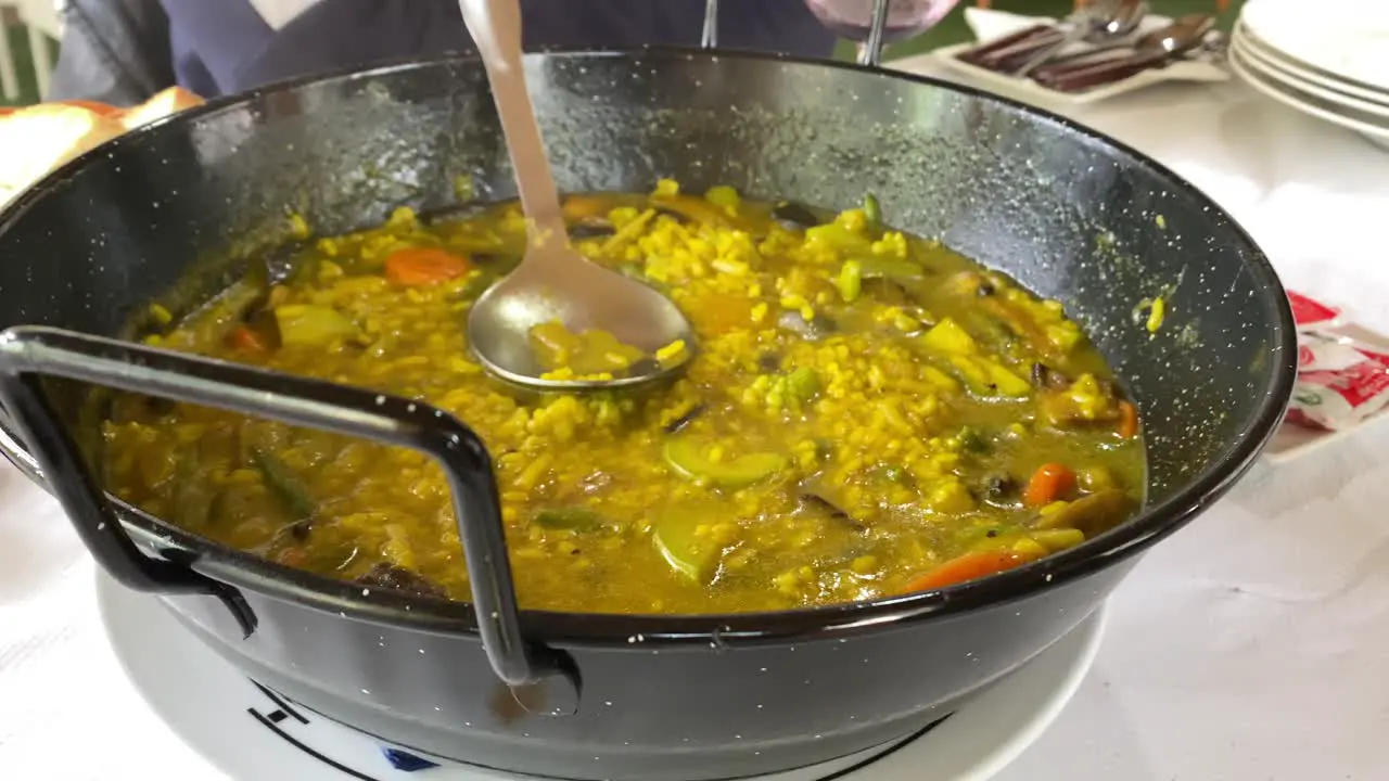 Close view of a Spanish soup rice paella in a restaurant