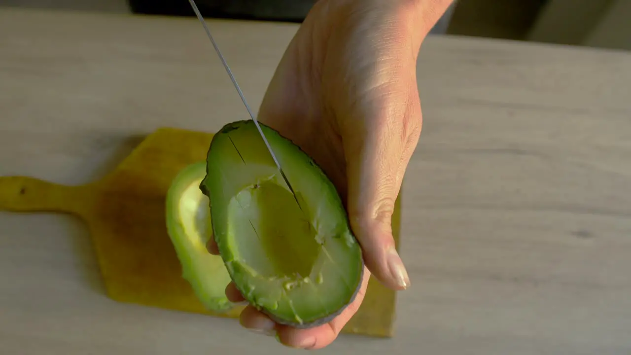 White woman cutting avocado