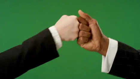 CU Colleagues fist bump on green screen