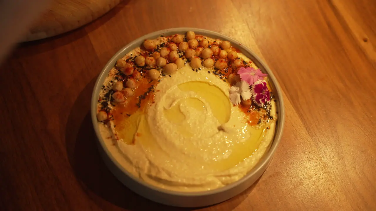 Professional Chief preparing a Hummus dish for their guests