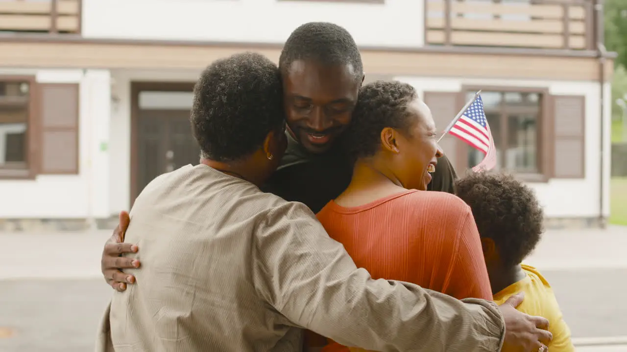 Male Soldier Hugging And Saying Goodbye To His Family Outside Home Before Going For Military Service 1