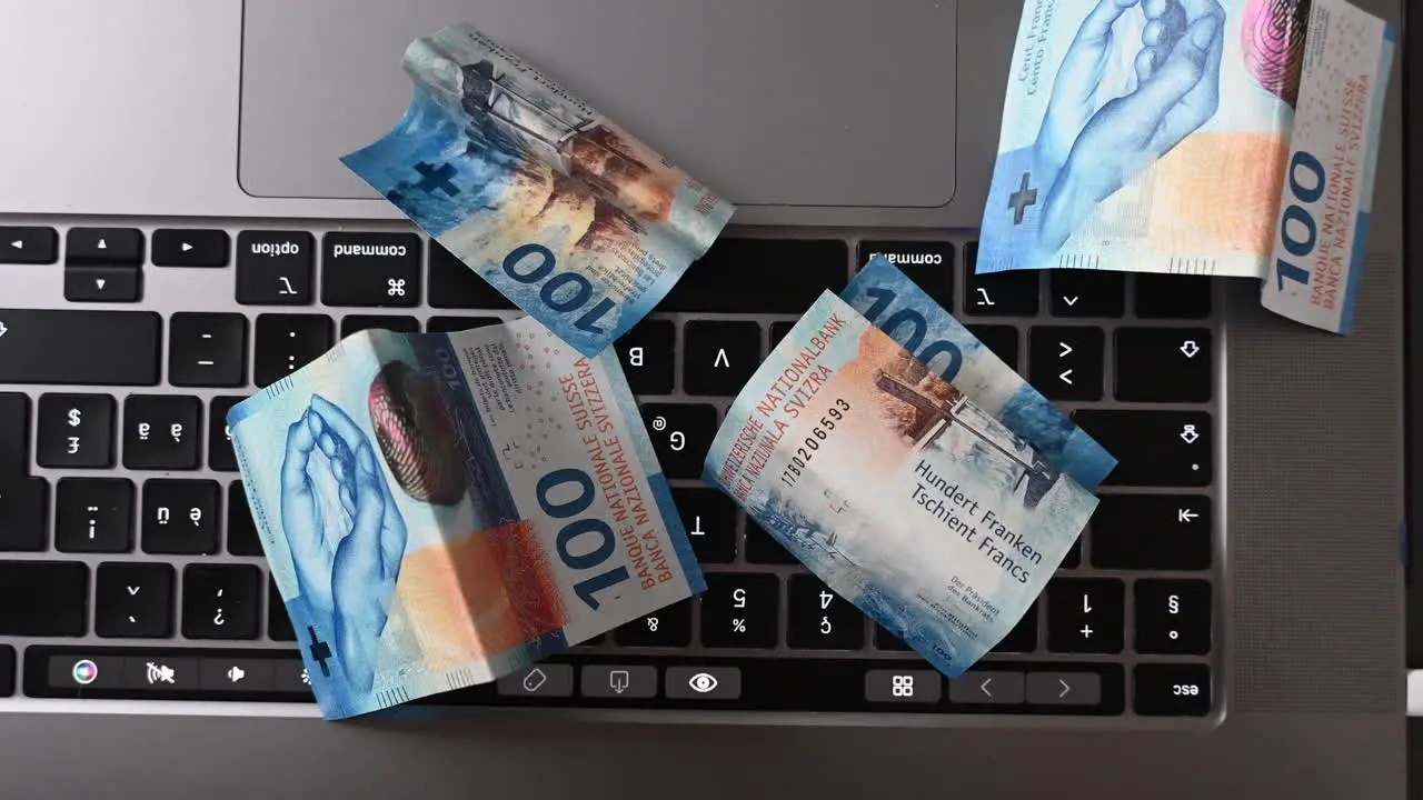 Top view of bank notes laying on a laptop keyboard made with an online business