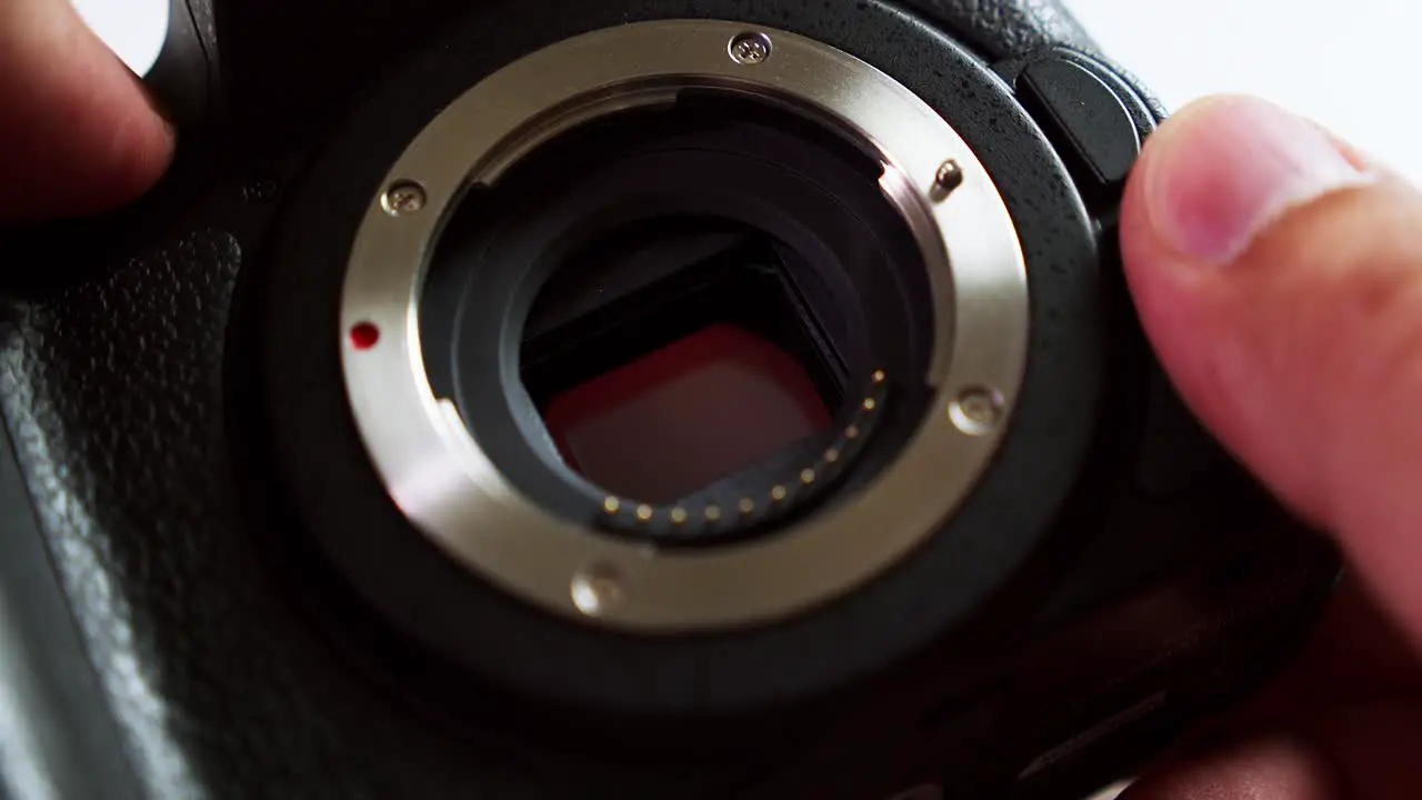 Close-up of a camera body while the technician is checking its sensor to see if it needs some cleaning or not