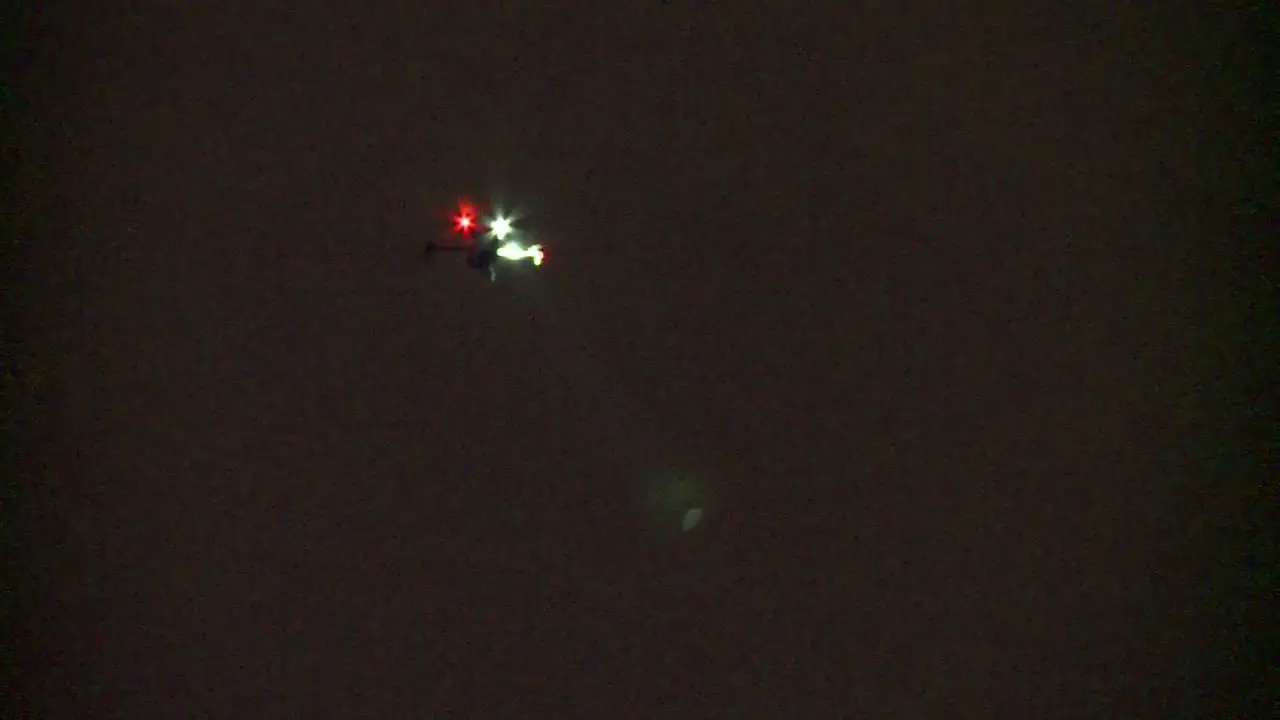 POLICE DRONE AT NIGHT SEARCHING WITH SPOTLIGHT