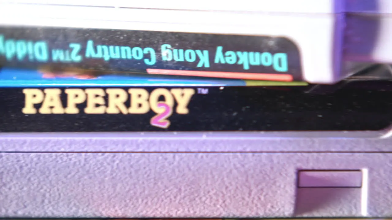 Top of Vintage Super Nintendo Cartridges in Purple Light SLIDE RIGHT